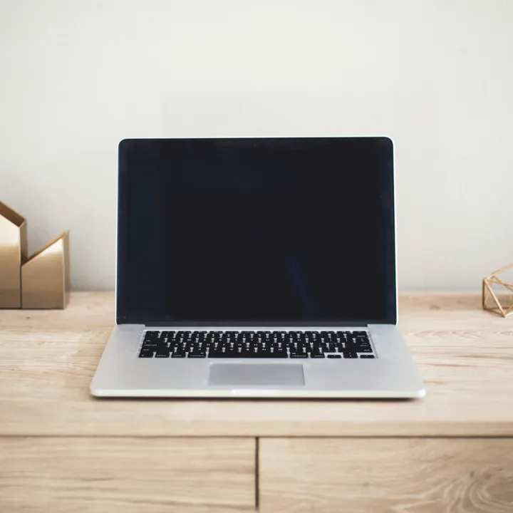 A laptop open on an empty desk